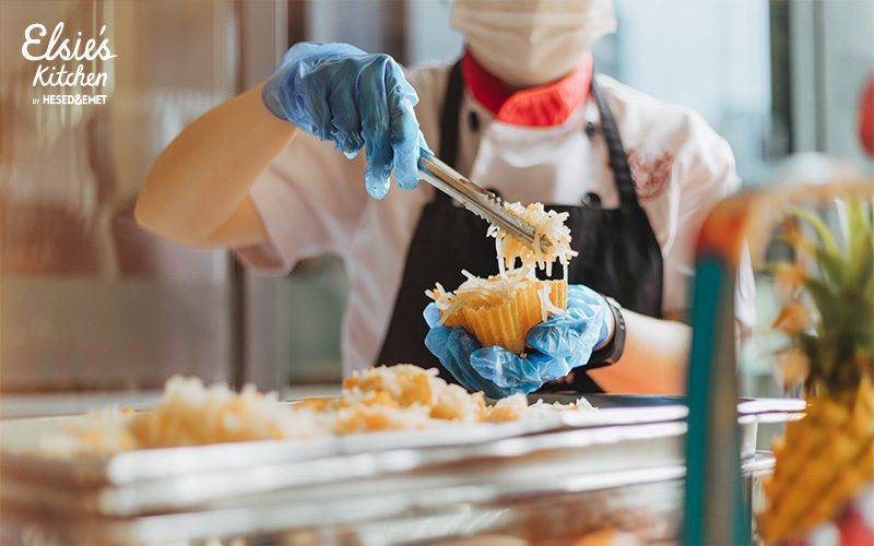 Catering chef in uniform carefully plating appetizers for an event