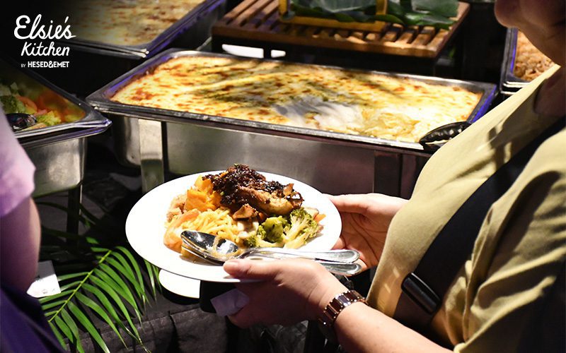 Guest holding a plated meal at a corporate catering event