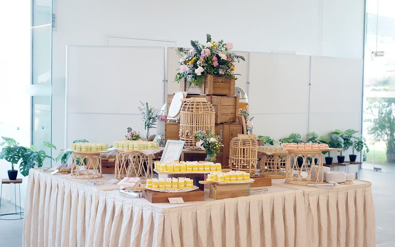 Rustic dessert table setup with wooden crates and birdcages.