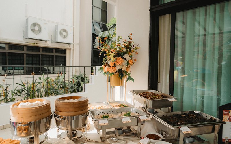 Stylish outdoor dim sum catering setup with bamboo steamers.