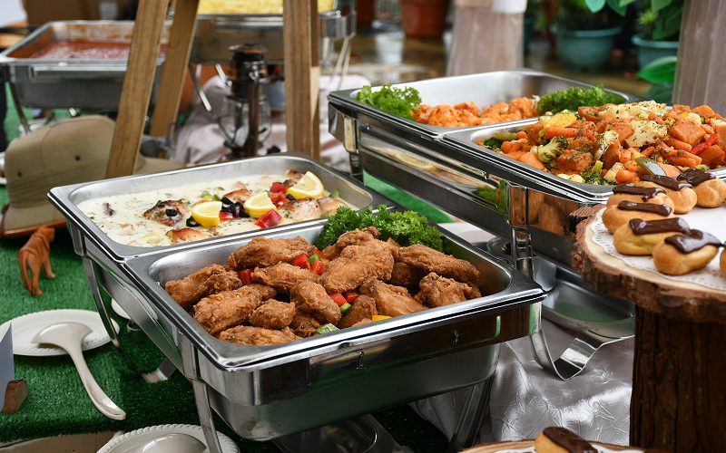Buffet spread with fried chicken and vegetables for diverse diets.