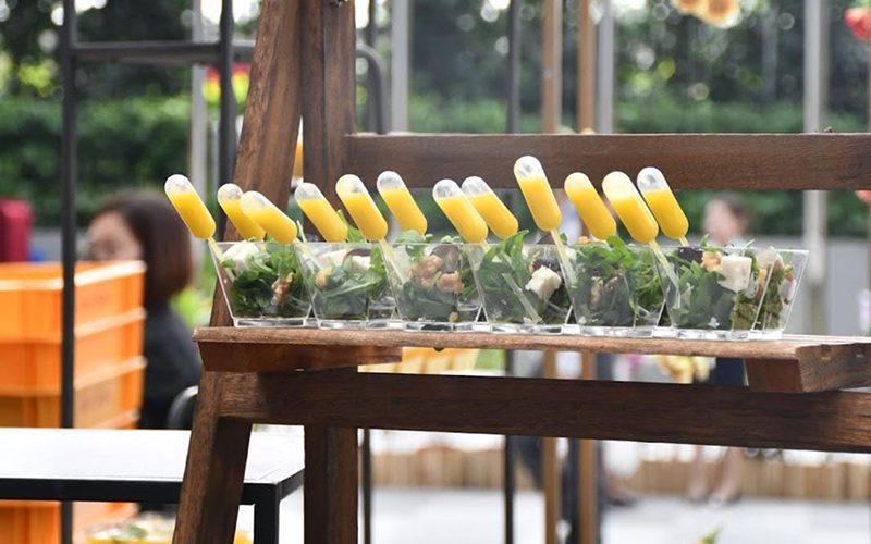 Individual salad cups with dressing pipettes for creative catering.