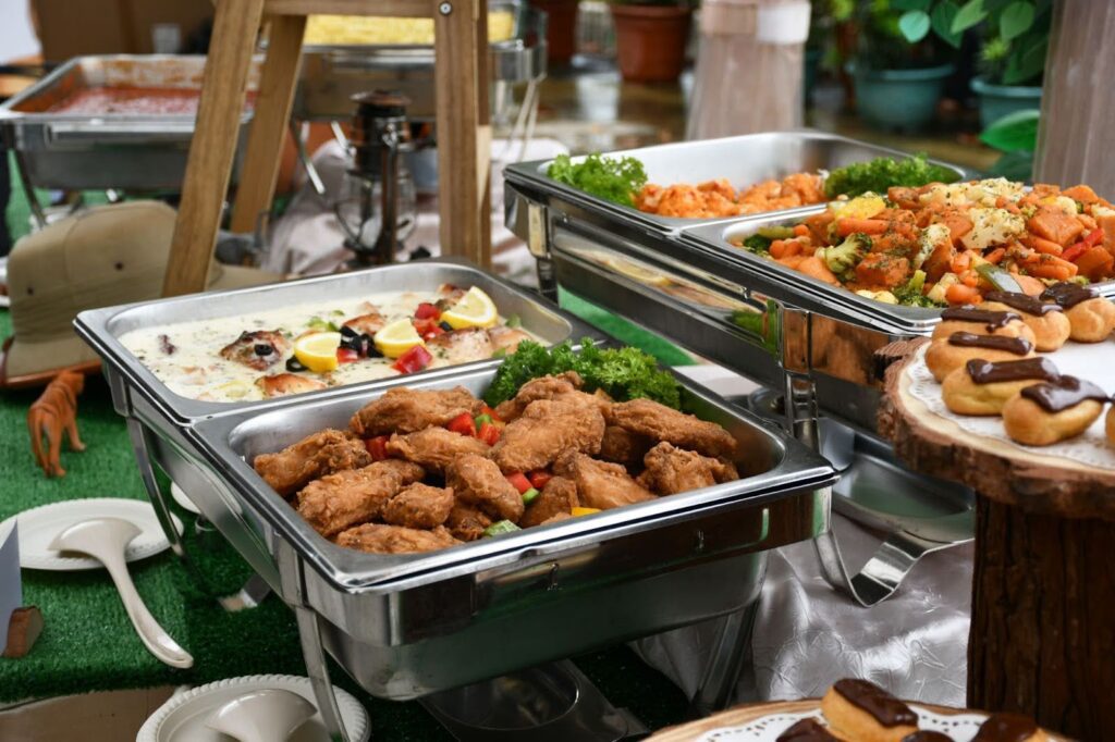 Fried chicken and eclairs served at a kiddie party.