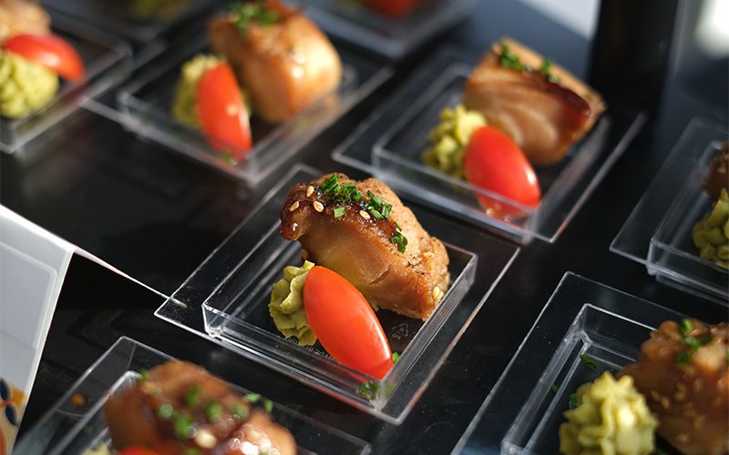 Individually portioned corporate catering samples showcasing modern menu variety.