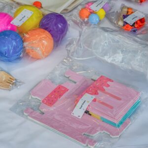 Assorted sweet treats and DIY party kit items arranged on a table