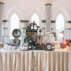 White themed wedding reception buffet setup with floral arrangements
